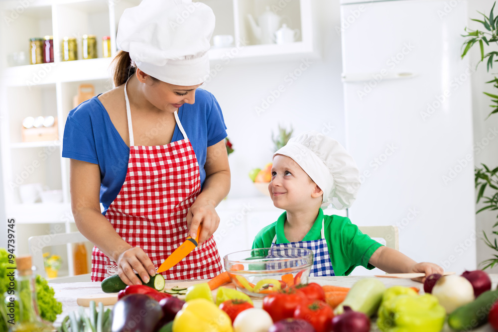 Beautiful mother with happy adorable son prepare food for dinner Beautiful mother with happy adorable son prepare food for dinner