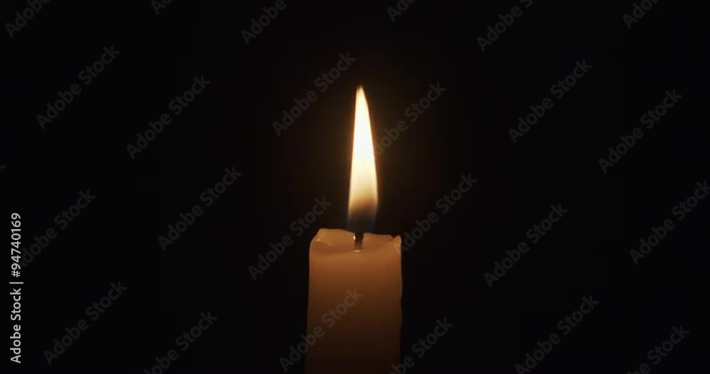 single candle burns on a dark background single candle burns on a dark background