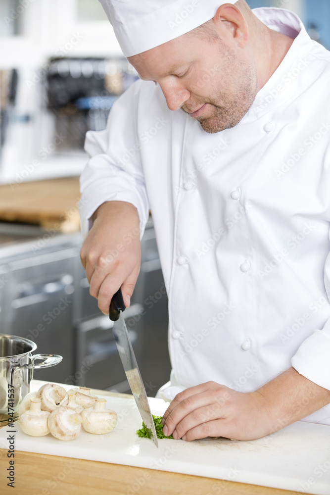 Fototapeta premium Professional chef preparing vegetables to a healthy dish