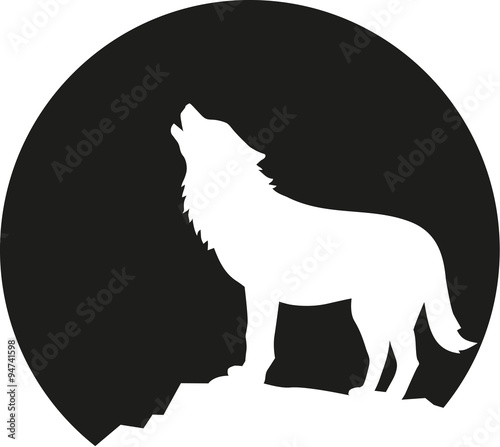 Howling wolf in front of the moon