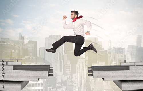 Wallpaper Mural Energetic business man jumping over a bridge with gap Torontodigital.ca
