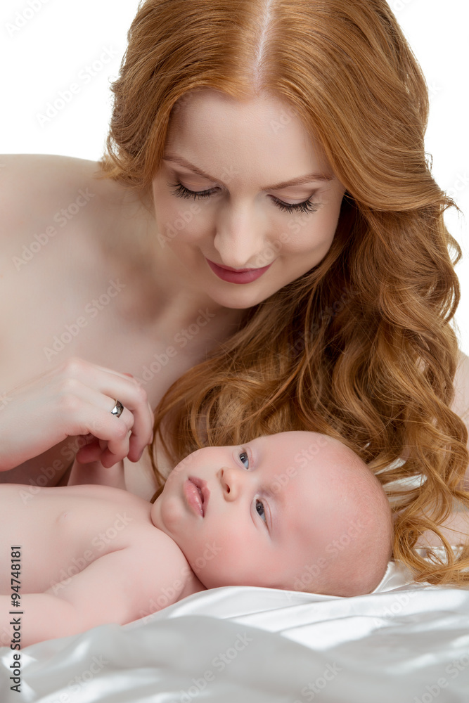 Pretty red-haired mother takes care of her baby Pretty red-haired mother takes care of her baby