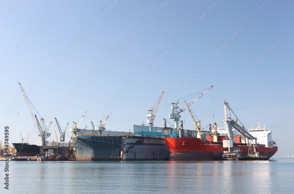 A large tanker repairs in dock. Shipyard