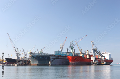 A large tanker repairs in dock. Shipyard