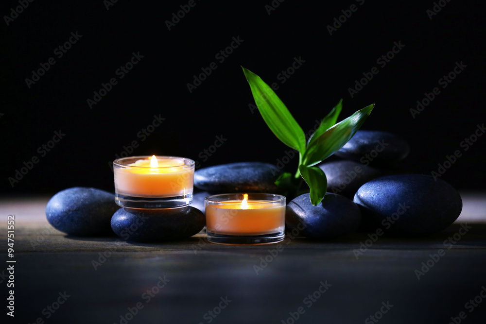 Spa stones and candles on dark background Spa stones and candles on dark background