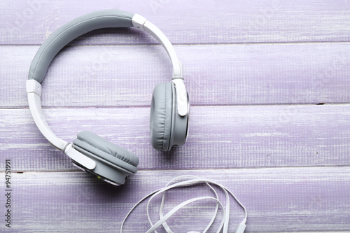 Headphones on wooden lilac background