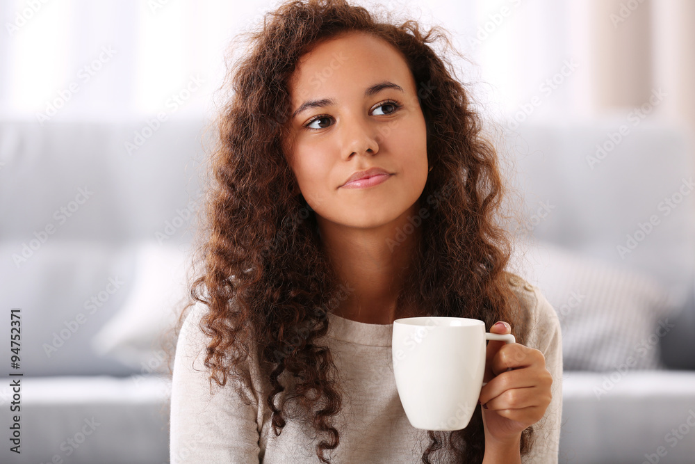 Close up portrait of pretty young woman drinking coffee in the room Close up portrait of pretty young woman drinking coffee in the room