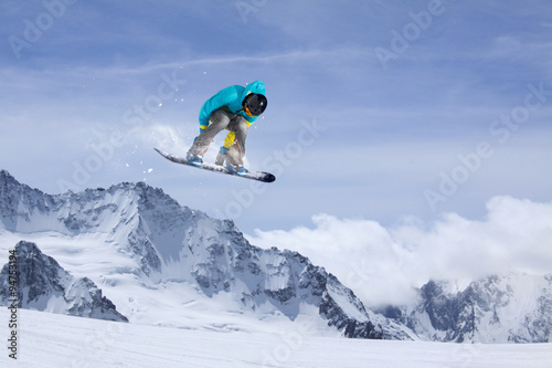 Flying snowboarder on mountains, extreme sport