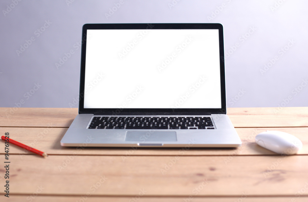 Laptop stands on a wooden table