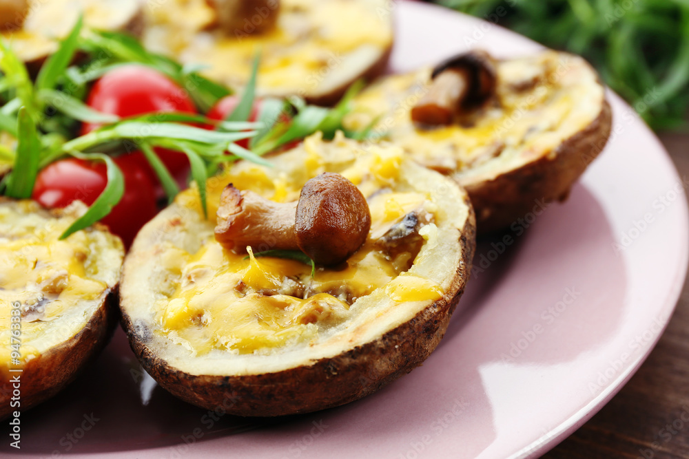 Baked potatoes with cheese and mushrooms on table close up