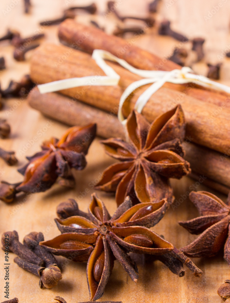 Star anise, cinnamon sticks and cloves on wooden table, seasoning for cooking Star anise, cinnamon sticks and cloves on wooden table, seasoning for cooking