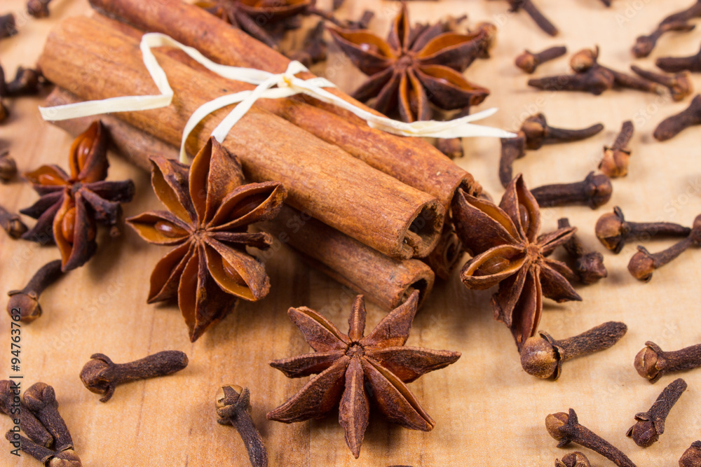 Star anise, cinnamon sticks and cloves on wooden table, seasoning for cooking Star anise, cinnamon sticks and cloves on wooden table, seasoning for cooking
