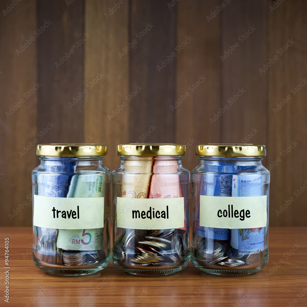 Image of money in three clear bottles with blank labels against Image of money in three clear bottles with blank labels against