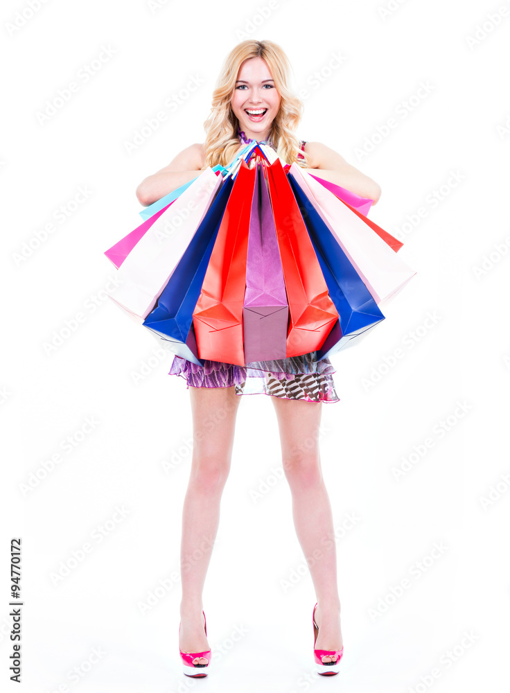 Happy blonde woman with colorful shopping bags.