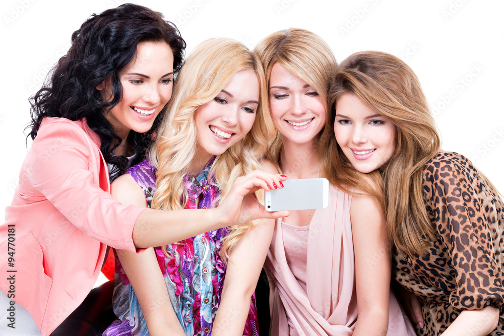 Smiling women looking at the mobile phone.