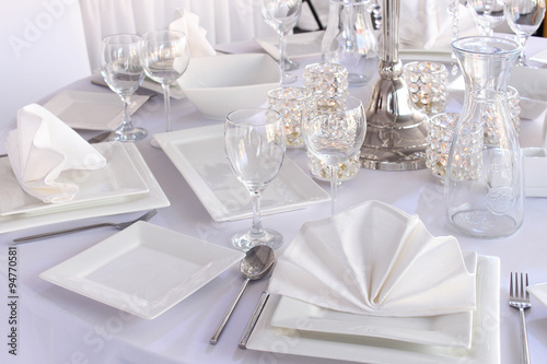 Table served with white square plates and wineglasses © milka-kotka