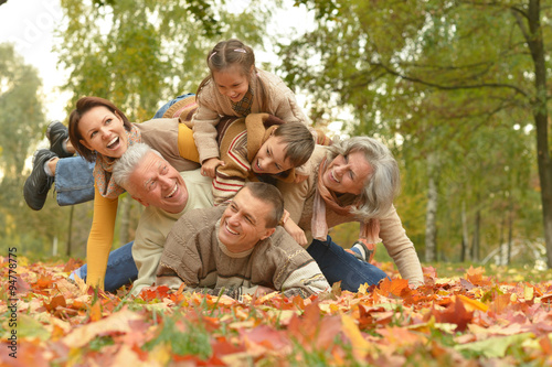 Family relaxing in autumn park