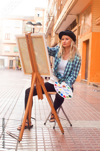 girl painting a picture on the street © alinaalis13