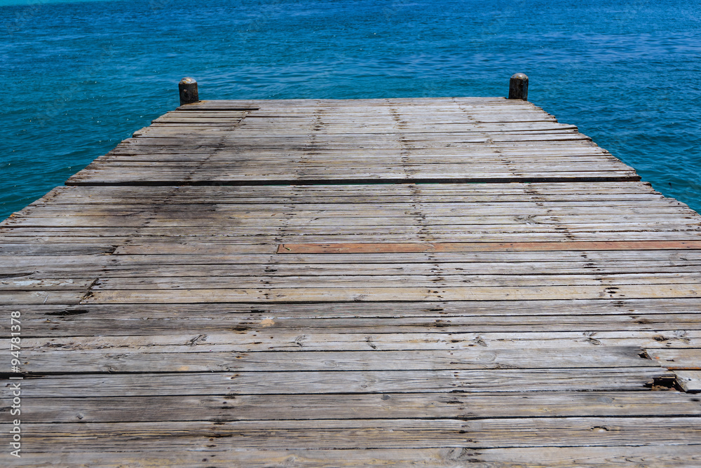 wooden bridge juts out into  of the sea