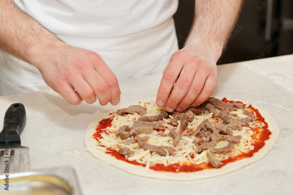 Making of a meat pizza