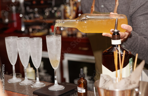 Bartender is pouring liquor in glass