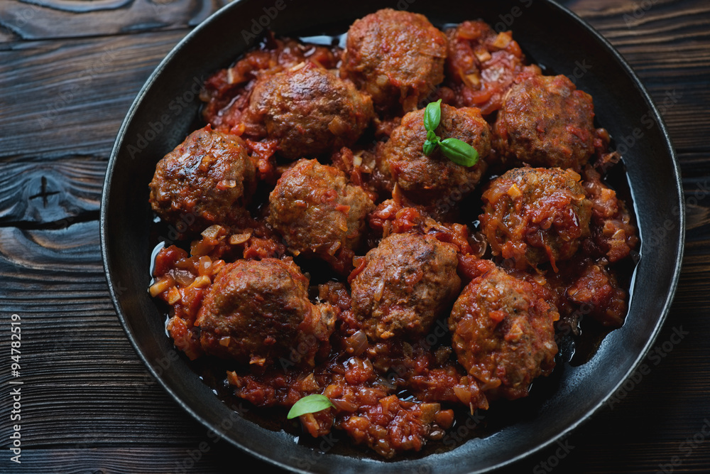 Frying pan with meatballs in tomato sauce, studio shot, close-up Frying pan with meatballs in tomato sauce, studio shot, close-up