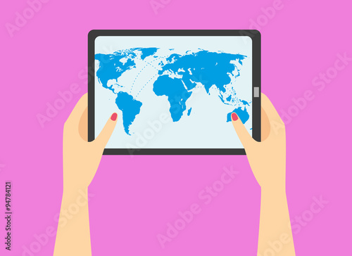 woman's hand holding a tablet with world map on the screen