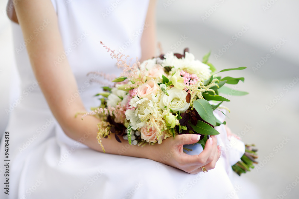 Bride holding a beautiful wedding bouquet Bride holding a beautiful wedding bouquet