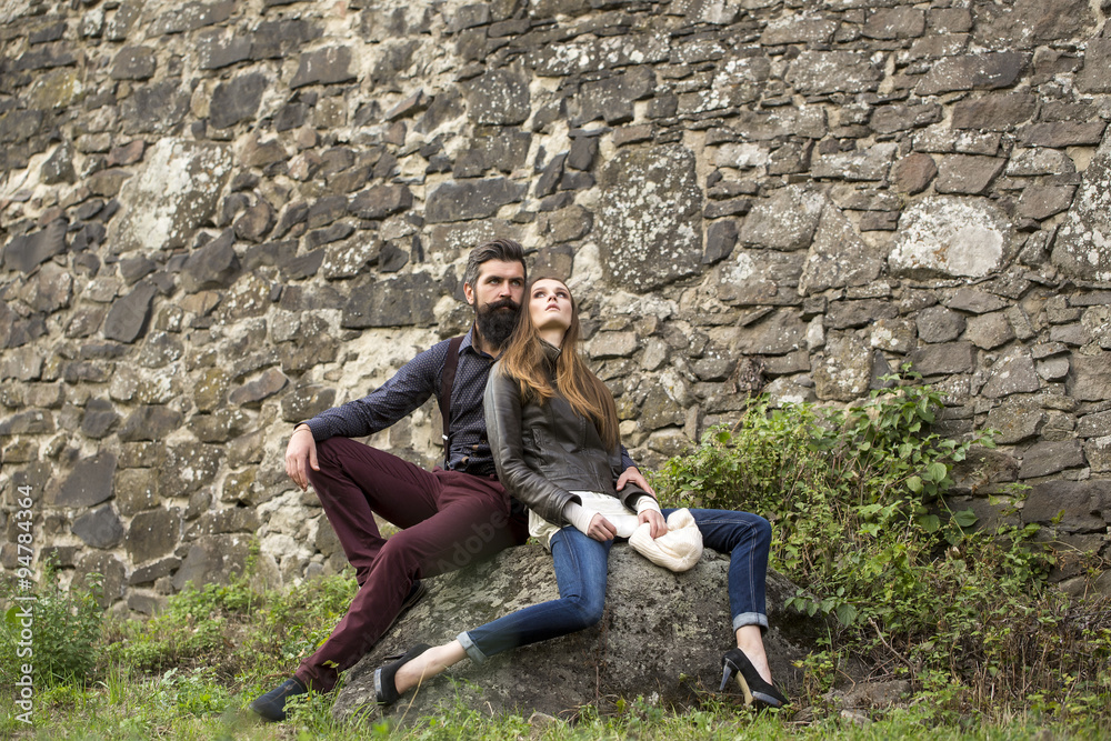 Couple near stony wall