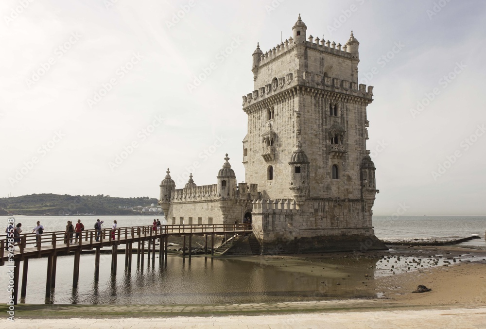 Belem Tower of Lisbon, Unesco world heritage, with people on the bridge