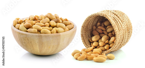 peanuts in the basket and wood bowl on white background photo