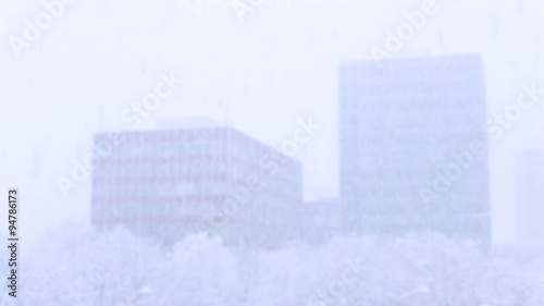 snows in the background blurred modern buildings