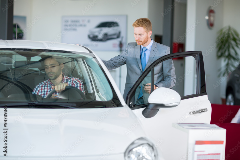 customer in car showroom with car seller