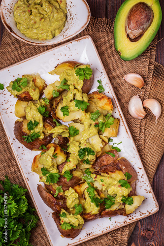 Baked potatoes served with guacamole