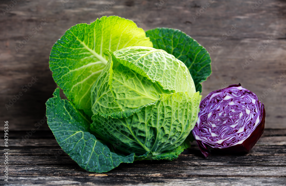 Fresh  Green cabbage and slice of Red cabbage on old wooden table