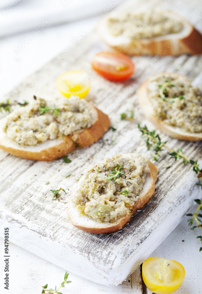 Bruschetta with green olives paste, tapenade on a white background