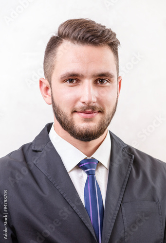 Caucasian young man smiling over white background