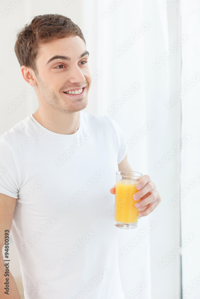 Handsome young man is enjoying healthy drink Handsome young man is enjoying healthy drink