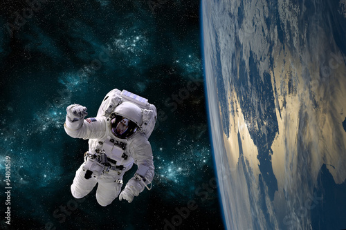 Canvas Print An astronaut floats in the zero gravity environment of space - Elements of this image furnished by NASA