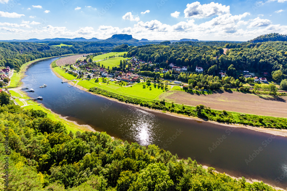 Fototapeta premium View from viewpoint of Bastei in Saxon Switzerland Germany to the town city and the river Elbe on a sunny day in autumn