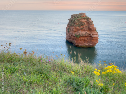 Ladram bay with red sandstone pillar, seen from clifftop. Devon, UK photo