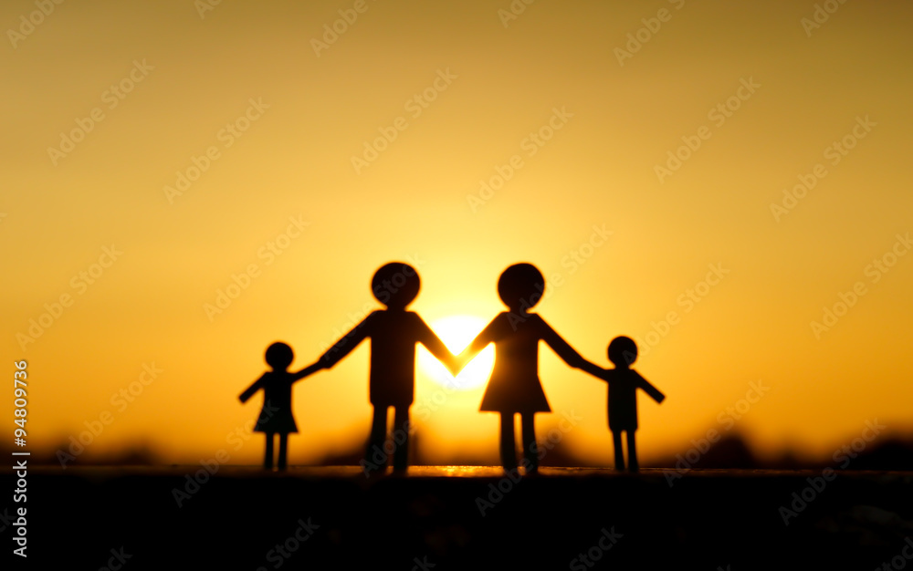 Abstract blurred background of paper cut of family with sunset background / Family Life Insurance / Protecting family / Family concepts