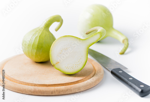 slice bottle gourd fruit  on wood plate on white photo