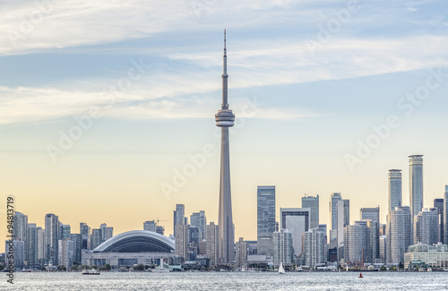 Toronto skyline with the CN Tower apex at sunset.