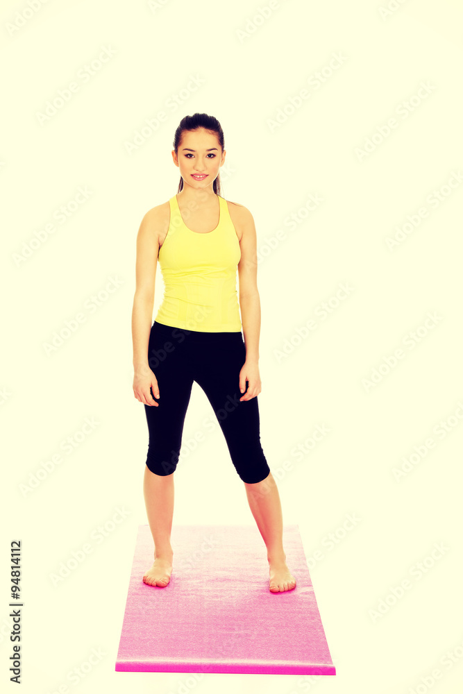 Active fitness woman on exercise mat.