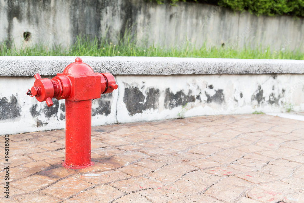 Red fire hydrant at busy walk pavement ready for emergency Red fire hydrant at busy walk pavement ready for emergency