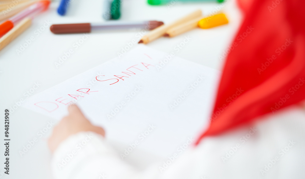 child before Christmas writes a letter to Santa child before Christmas writes a letter to Santa