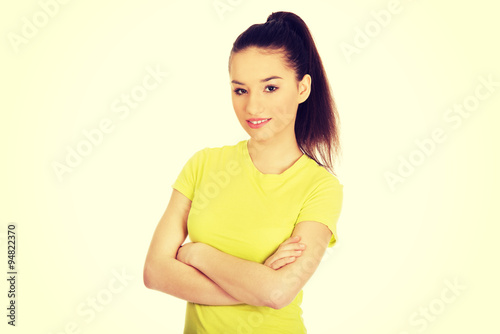 Friendly smiling woman with crossed arms.