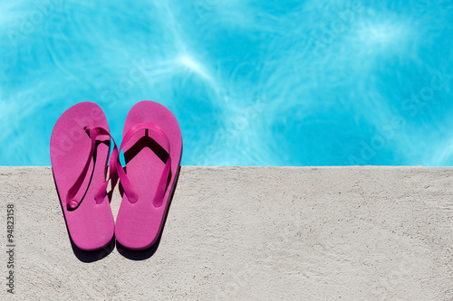 Pink slippers near swimming pool