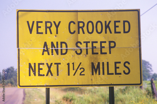 A sign that reads ÒVery crooked and steep next 1 1/2 milesÓ